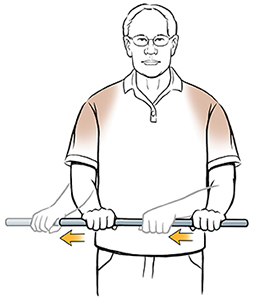 Man doing external rotation shoulder exercise with stick.
