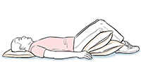 Person lying on back with pillows under head and knees.