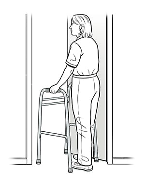 Female with walker moving through doorway. 