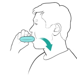 Person holding inhaler to their mouth, inhaling medicine.